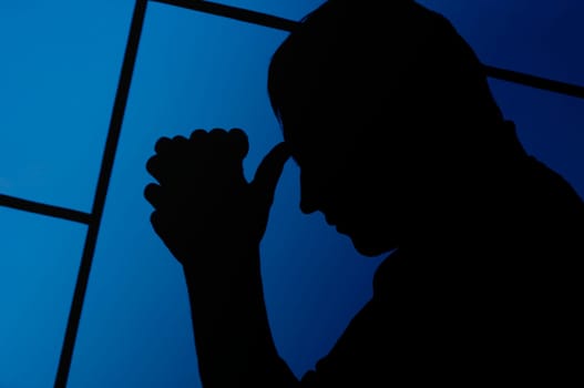 Silhouette of a man praying