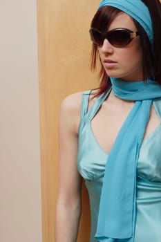 Woman with sunglasses and blue dress