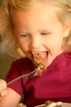 Little girl eating cake