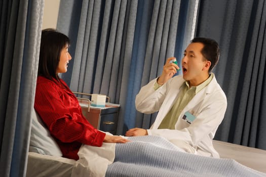 Doctor demonstrating inhaler to patient