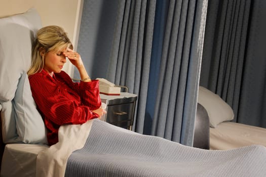 Female patient with hand over her face