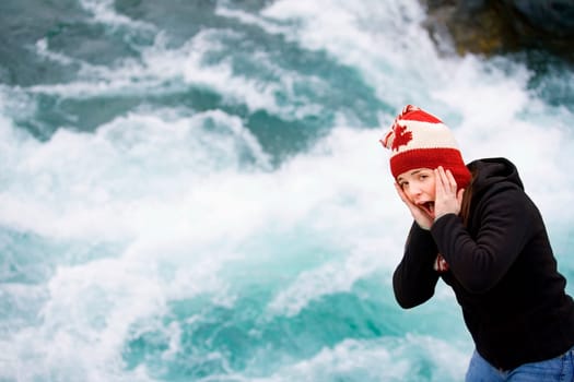 Young person by rushing rapids