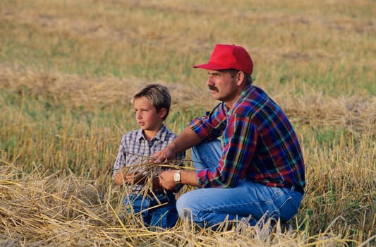 Farmer and son in field