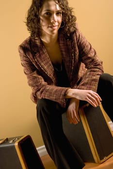 Woman sitting on suitcase