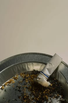 Cigarette butt in ashtray receptacle