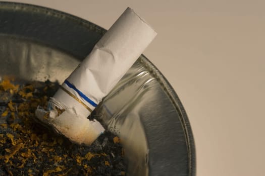 Cigarette butt in ashtray receptacle