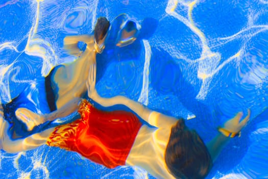 Kids swimming underwater