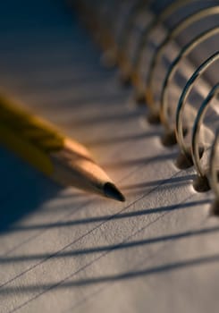 Sharpened pencil on coiled notebook