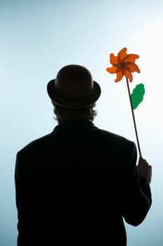 Person holding a flower pin wheel