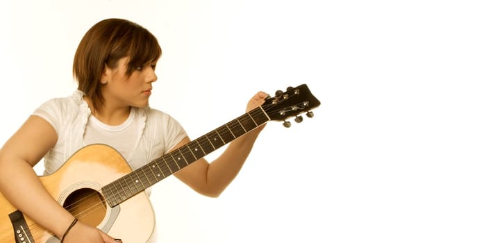 Woman tuning a guitar