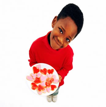 Boy holding plate of heart cookies