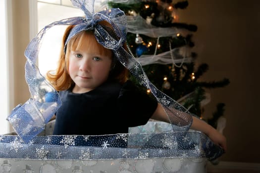 A child inside a large gift-wrapped box