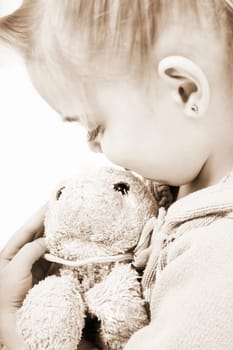 Child holding soft toy