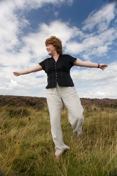 Woman balancing in a field