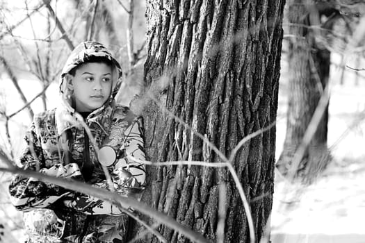 Teenage Boy Hunting In A Snow Covered Wooded Area
