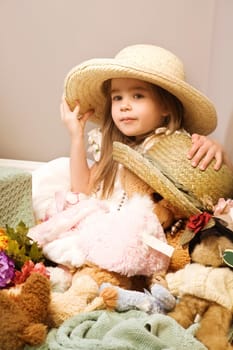 Girl and teddy bear wearing straw hats