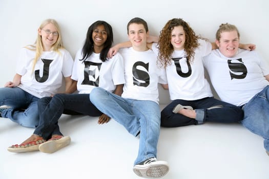 Five teenagers with t-shirts spelling Jesus
