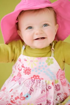 Happy baby girl in pink hat