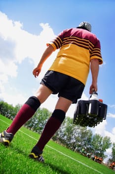 Rugby player on the sideline with refreshments