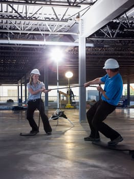 Engineers playing tug of war on construction site