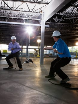 Engineers playing tug of war on construction site