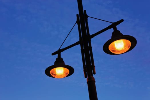 Street lamps against blue sky