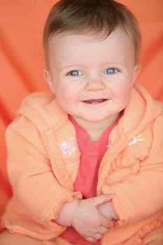 Baby girl in orange jacket