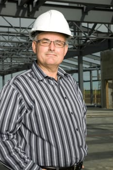 Man in hardhat in partially built building
