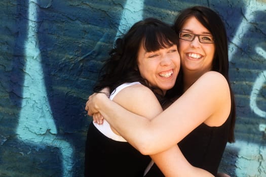 Two women hugging each other