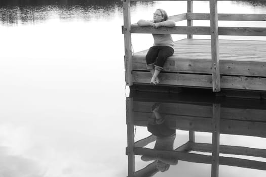 Girl sitting on a dock