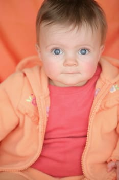 Baby in orange jacket