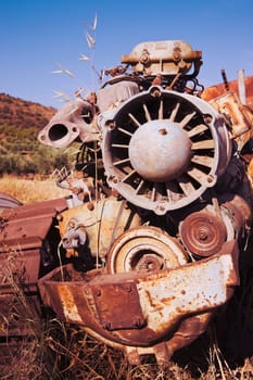 Rusting farm machine abandoned in field