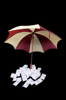 Umbrella covering piles of money
