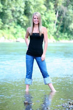 Teenage girl standing in water
