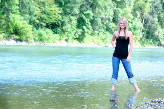 Teen girl standing in stream