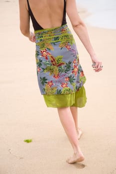 Woman walking along the beach