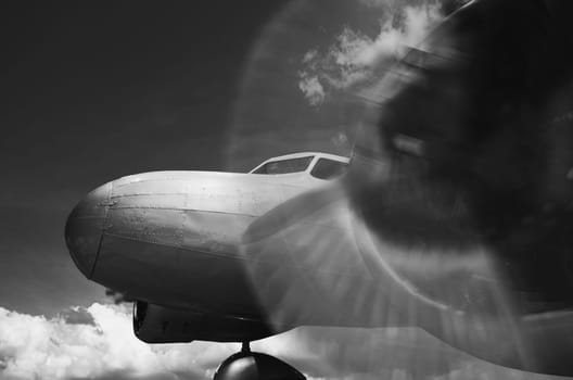 Vintage twin engine airplane with propeller rotating in black and white