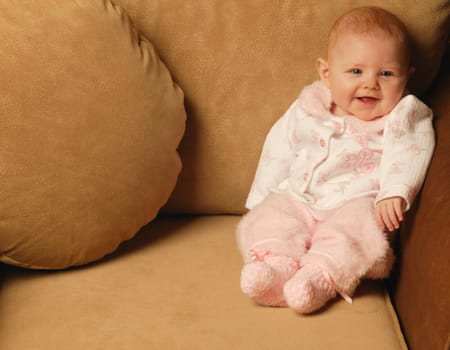 Baby girl smiles in chair