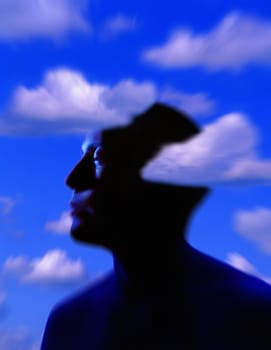 Silhouette of man's head with cloud background