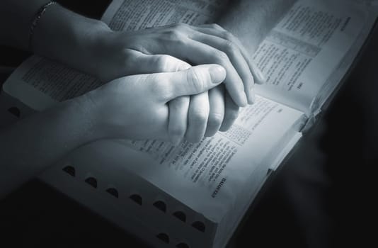 Holding hands over the Bible