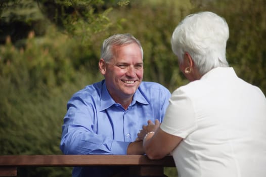 Couple sits outside together
