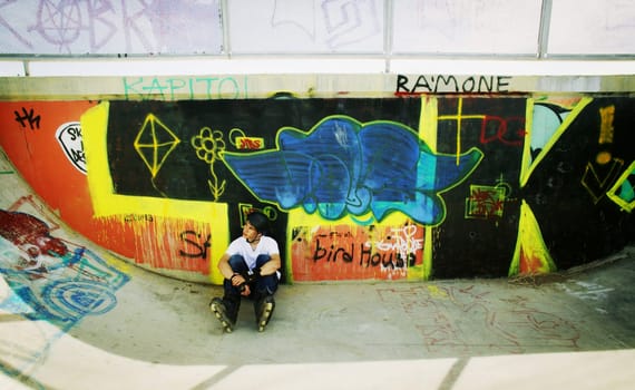 Skater sitting in park