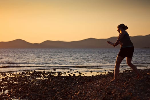 Stone throwing by the sea