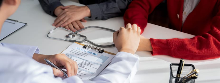 Couple attend fertility or medical consultation with gynecologist at hospital as family planning care for pregnancy while doctor and husband consoling young wife through appointment. Panorama Rigid