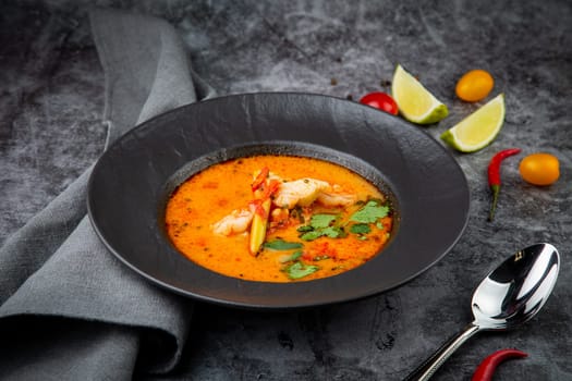 tom yam soup with chicken, lime, cherry tomatoes and parsley