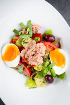 salad with soft-boiled egg, tuna, green onions, boiled potatoes