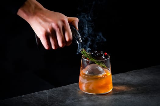 aromatic cocktail with a sprig of pine needles and round ice