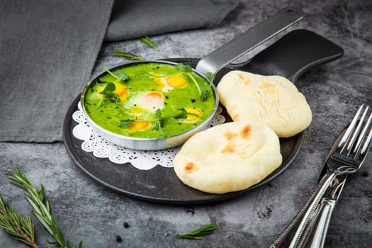 green broccoli soup with egg and herbs