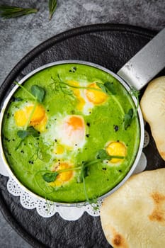 green broccoli soup with egg and herbs