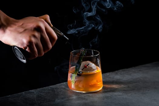 aromatic cocktail with a sprig of pine needles and round ice